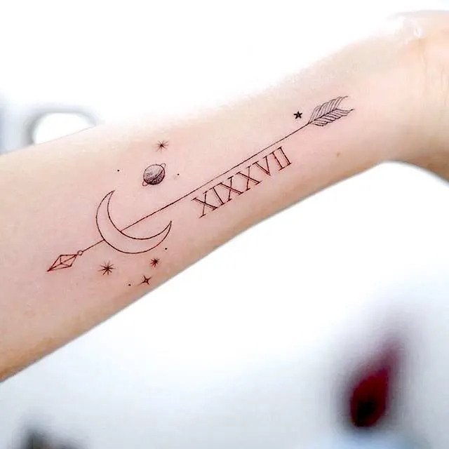 A girly moon and arrow tattoo by @tattoo.umg_