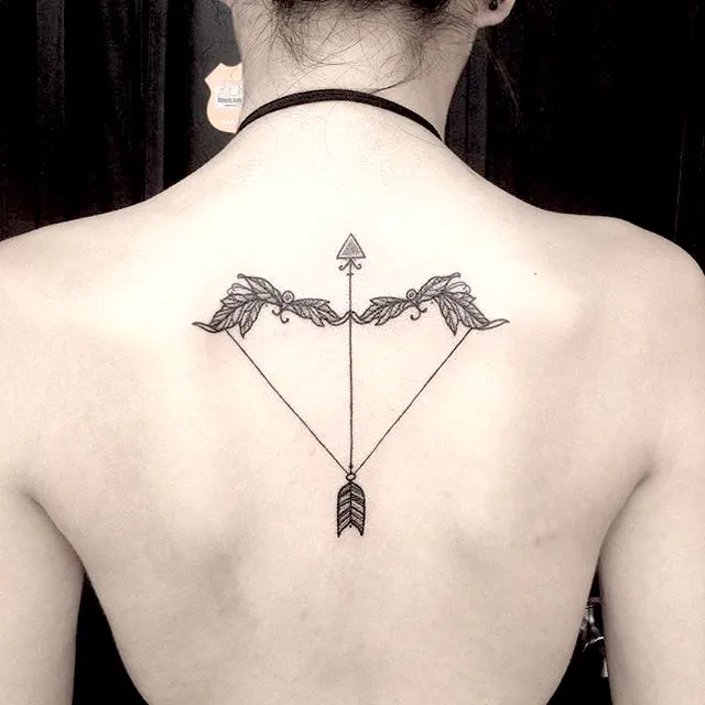 A symmetric back tattoo of arrow and bow by @kelsey_moore_tattoo