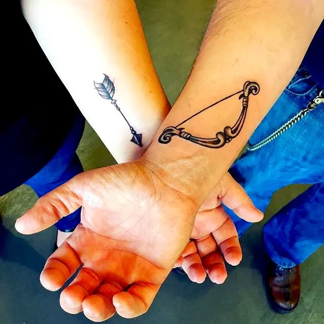 Arrow and bow matching couple tattoos by @cherylking78