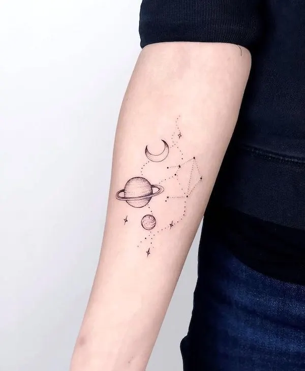 A cute universe forearm tattoo by @nothingwildtattoo