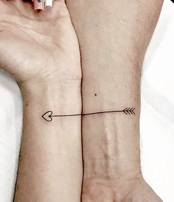 Connected arrow wrist tattoos by @tudor.tatts_