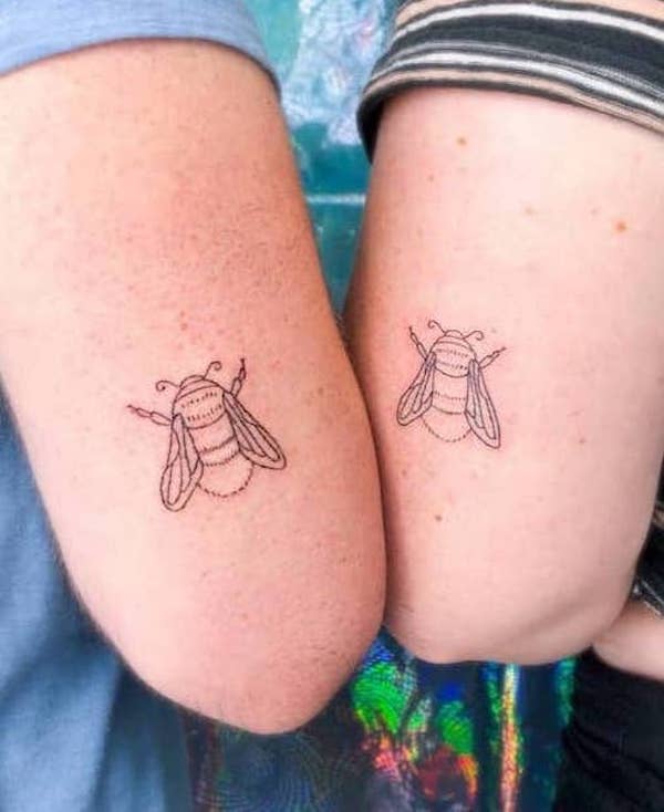 Matching bee tattoos on the arm by @minjiyang_tattooer