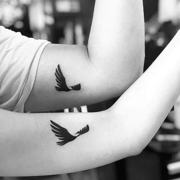 Matching bird tattoos on the arm by @ritualpolanco