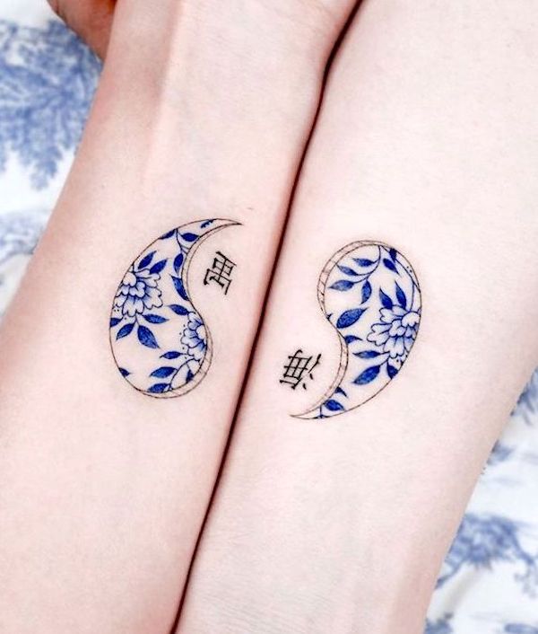 Oriental matching yin and yang wrist tattoos by @e.nal_.tattoo