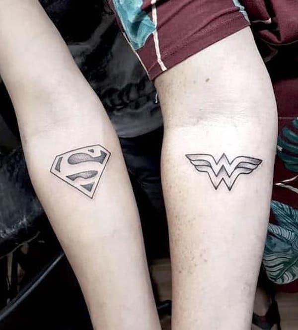 Superman and Wonder Woman tattoos by @revengetattoo66