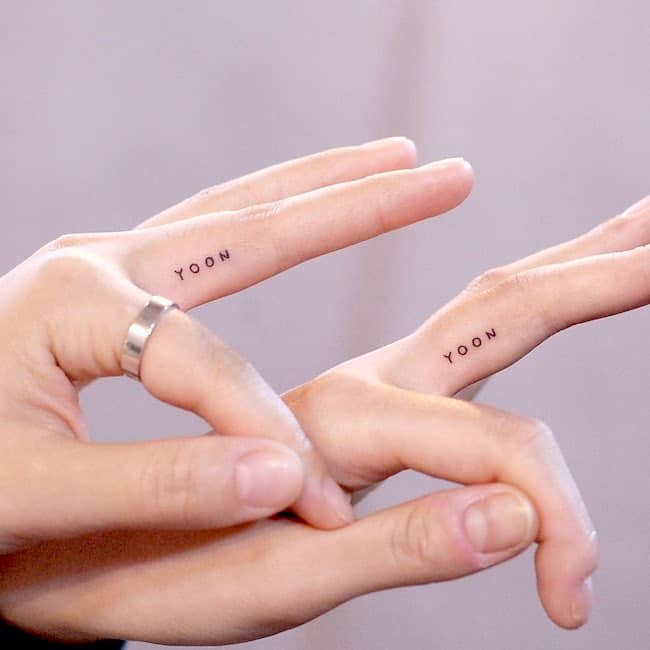 Tiny letter tattoos on finger by @wittybutton_tattoo