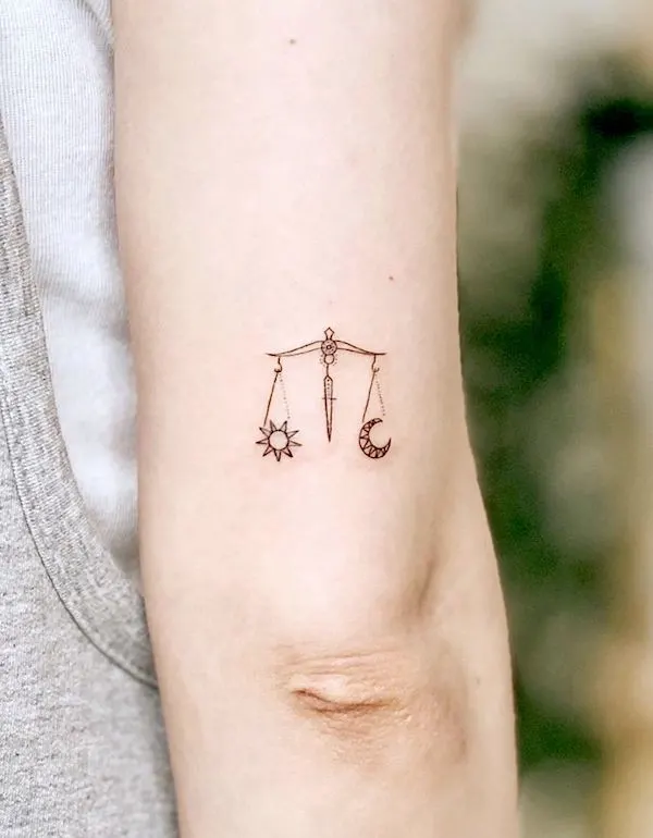 A dainty and sleek scale tattoo by @dalgu_tattooer - Libra symbol and constellation tattoos