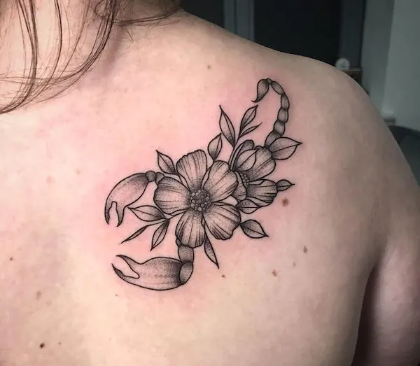 A floral Scorpio tattoo by @hier.und.jetzt.tattoo - Scorpio tattoos for women that are pure dark aesthetics