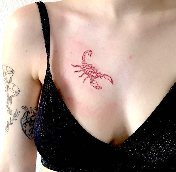 A small red scorpion on the chest- Scorpio tattoos for women