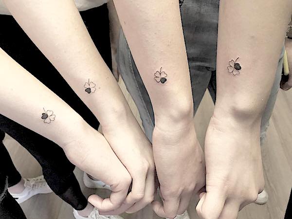 Small clover tattoos for 4 by @selcuksakre.tattooartist-- Minimalist matching tattoos for siblings