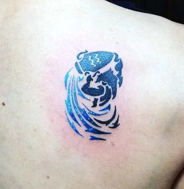 An Aquarius shoulder blade tattoo with stunning colors by @khristianismo