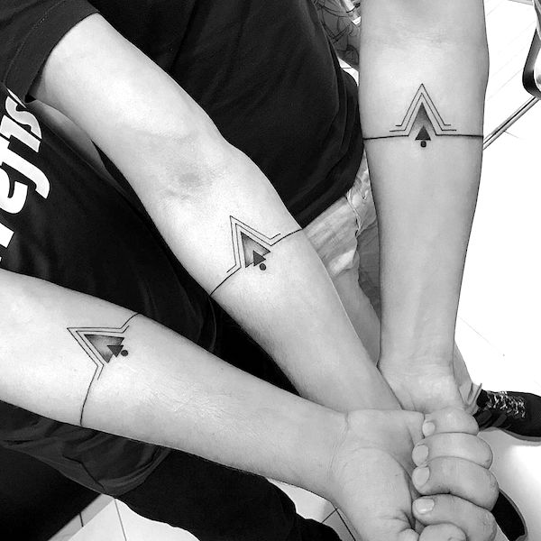 Matching arrow forearm tattoos by @paulomazotti- Bold and creative tattoos for brothers