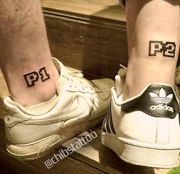 Player 1 and Player 2 matching ankle tattoos by @chibstattoo- Bold and creative tattoos for brothers