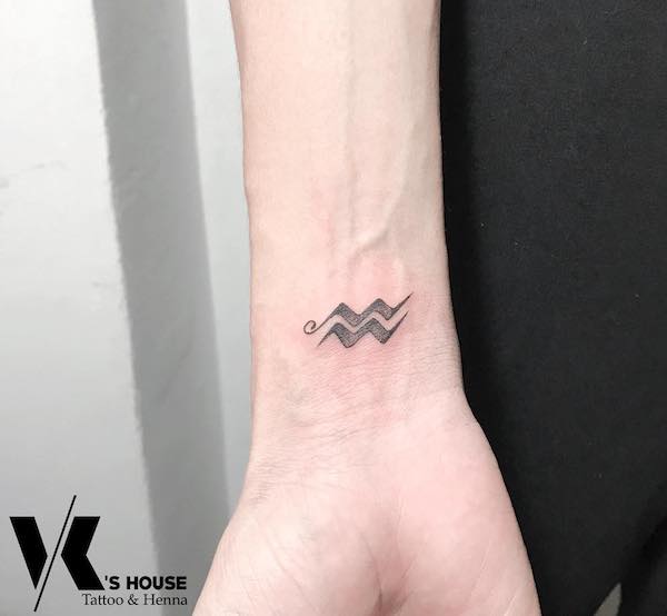 Aquarius symbol tattoo for men