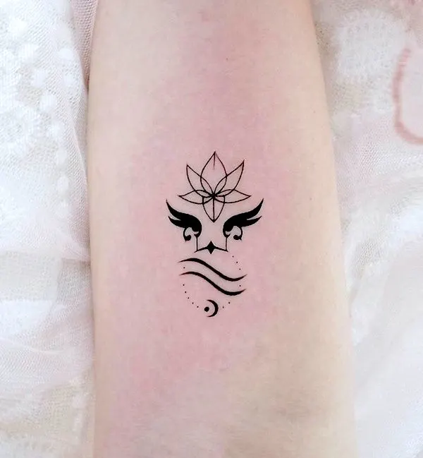 A symbol tattoo that combines Uranus, Aquarius and lotus by @kissa.tattoo