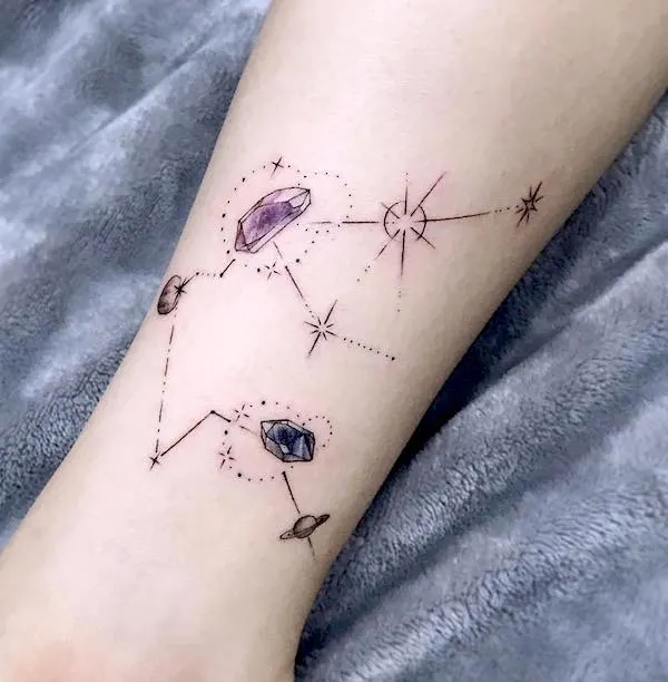 A gemstone tattoo in the shape of Aquarius constellation by @tattooist_daone