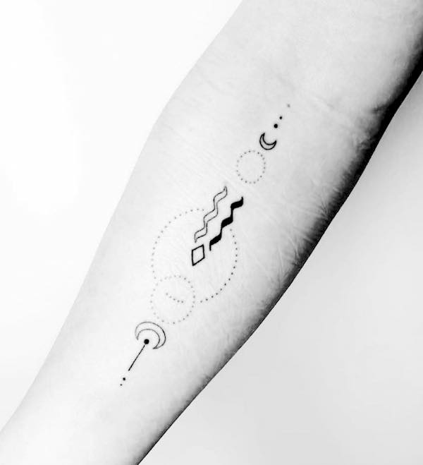 A black and white Aquarius arm tattoo by @handpoke.byarlette