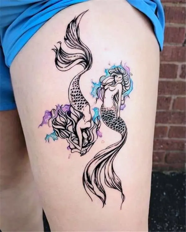 A double mermaid thigh tattoo for Pisces women - Fish tattoos to showcase your Pisces pride