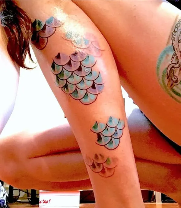 Mesmerizing scales tattoo on the calf by @mermaid_flows - Pisces symbol and constellation tattoos