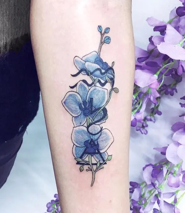 An elegant orchid tattoo for Aquarian girls by @charlotteglatt_tattoos 