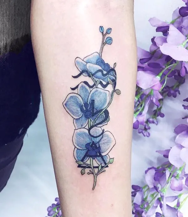 An elegant orchid tattoo for Aquarian girls by @charlotteglatt_tattoos
