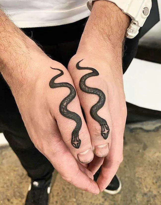 Bold snake tattoos on both thumbs by @blkttt - Creative thumb tattoos