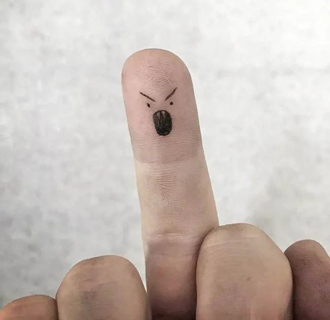 A cute emoji tattoo on the finger tip by @dexael.art- Dainty finger tattoo ideas