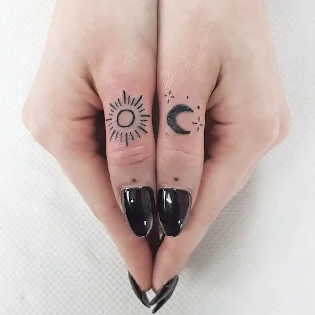 Contrasting sun and moon thumb tattoos by @handpoked_gelfwai- Creative thumb tattoos