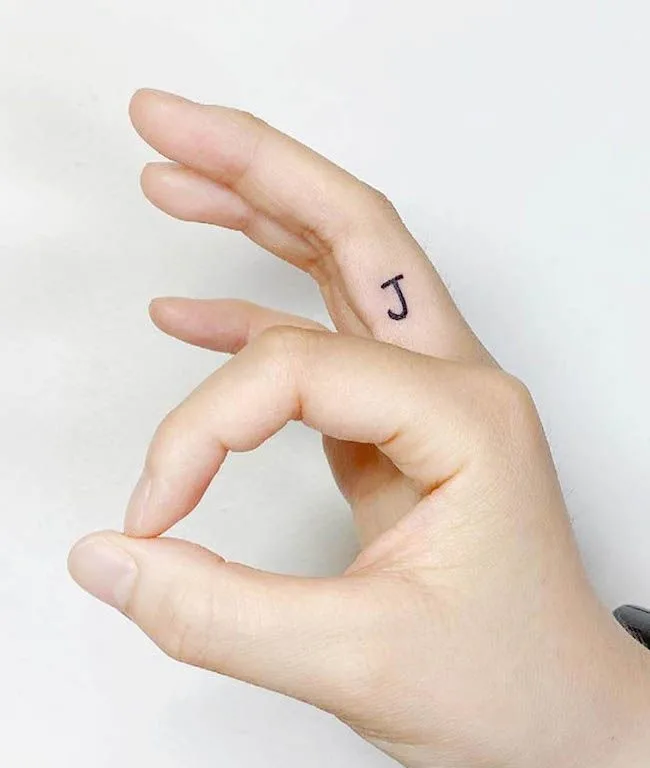A minimalist initial tattoo on the inner finger by @heze_tattoo- Dainty finger tattoo ideas