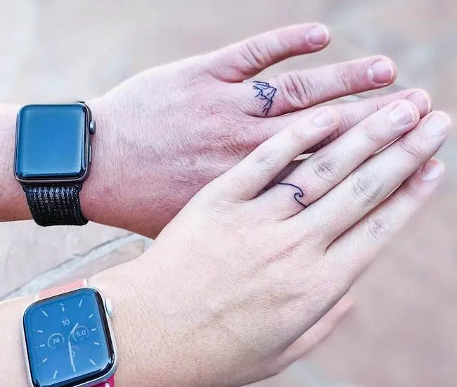 Mountain and ocean matching ring finger tattoos by @jdot5512 - Matching finger tattoos for couples