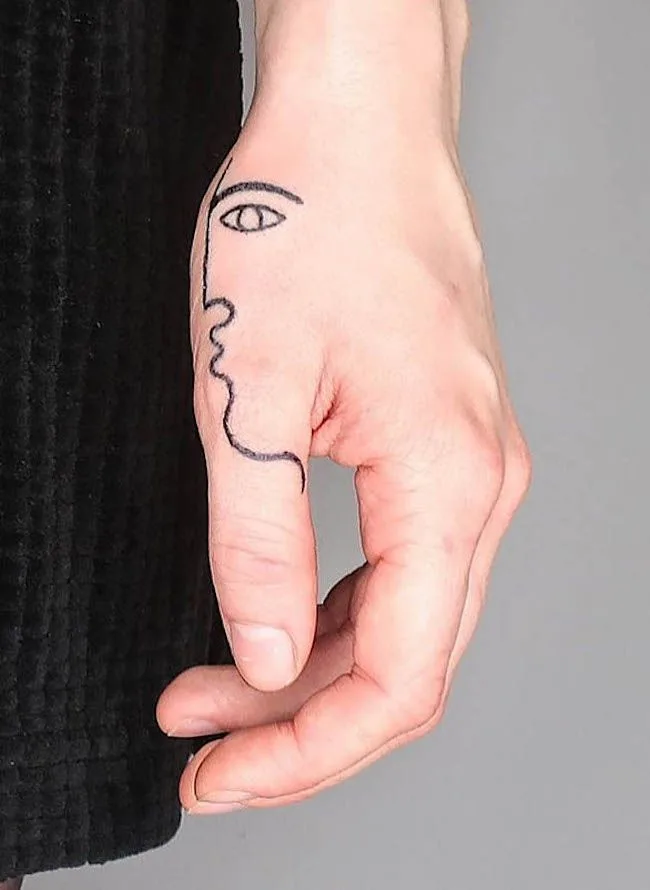 An artistic face tattoo by @madame_unikat- Creative thumb tattoos