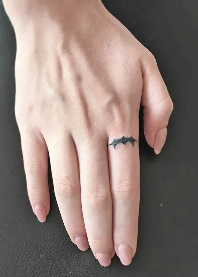 A small Batman tattoo on the index finger by @sasha.yurieva- Dainty finger tattoo ideas