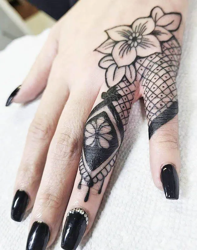 A cover-up lace tattoo by @shannongatesart - Bold statement finger tattoos