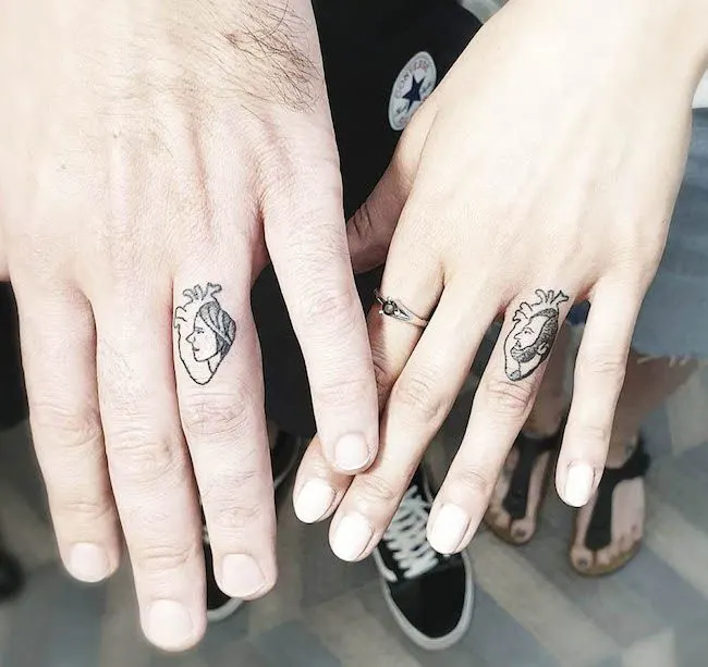 The beating heart couple tattoos by @siminamina - Matching finger tattoos for couples