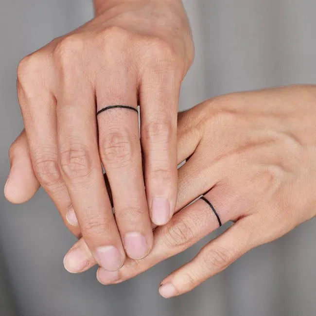 Matching single line ring finger tattoos by @tattooer_jina - Matching finger tattoos for couples