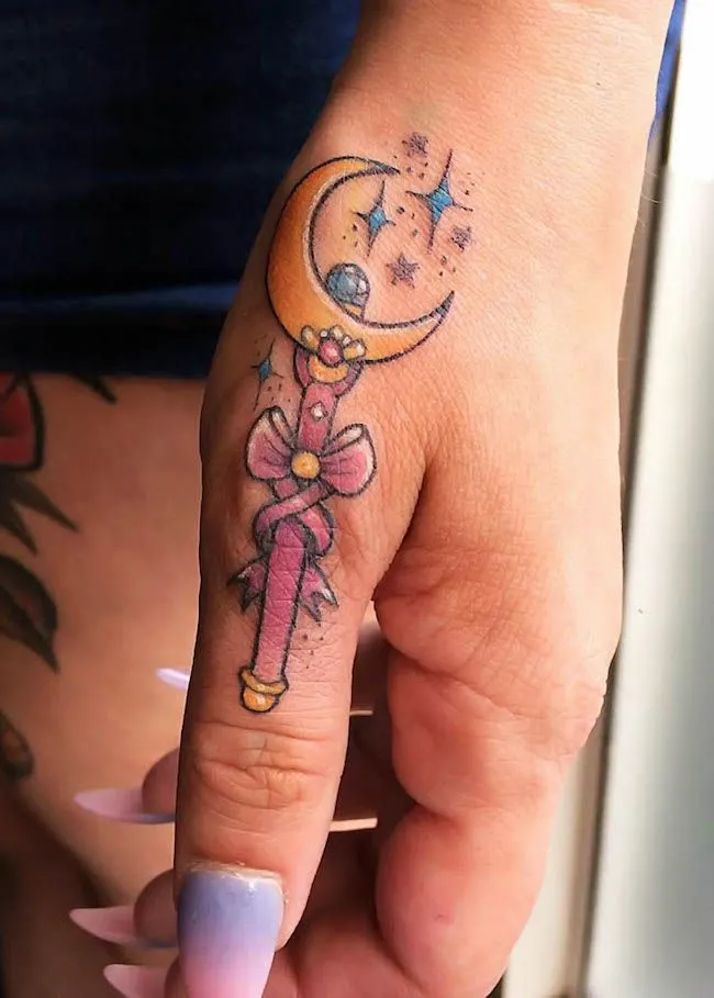 A magical Sailor Moon wand tattoo by @tibbles.tattoo- Creative thumb tattoos