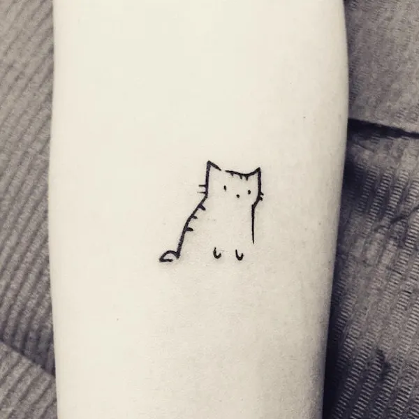 A cute little cat outline tattoo by @little.tattoos 