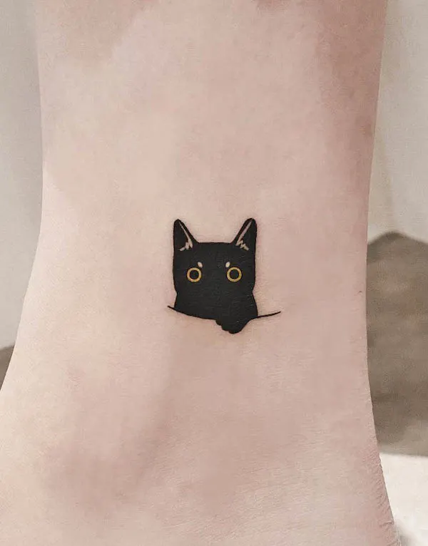 A small black cat tattoo by @tattoo_artist_olive- Minimalist tattoos for cat lovers