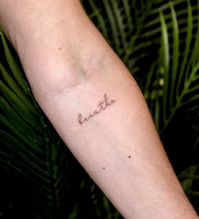 Breathe - one-word tattoo by @kyla_rose_tattoo