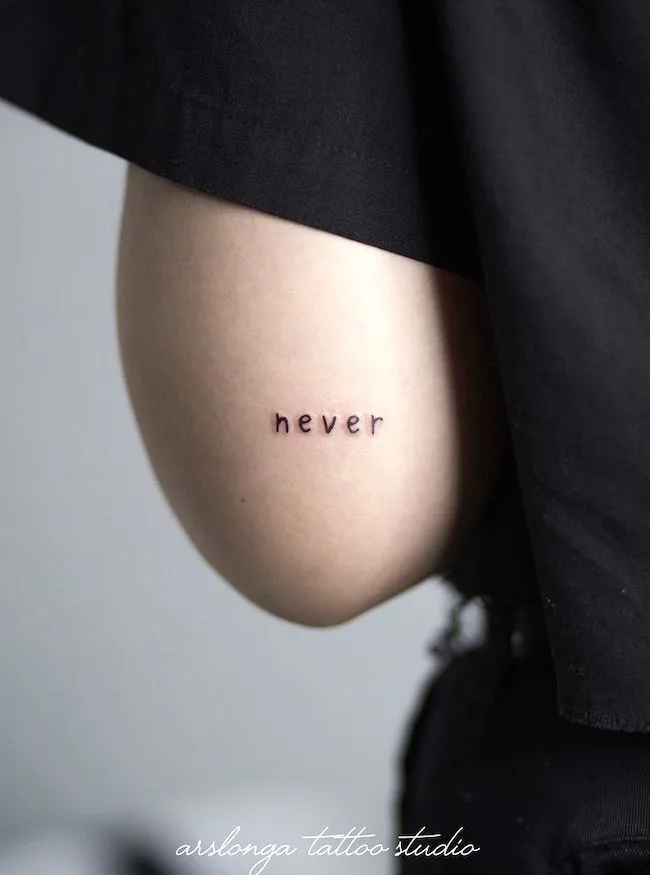 Never - one-word statement tattoo by @arslonga_tattoo