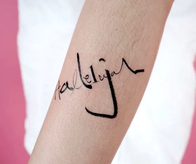 Hallelujah - a fun lettering tattoo on the forearm by @tattooist_doy