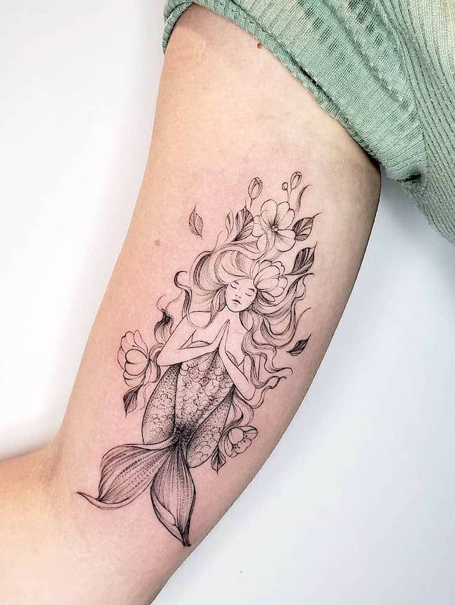 A detailed floral siren by @karoldiastattooist