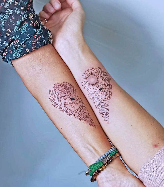 Delicate floral patterns in the shape of a heart - Mother-daughter tattoo by @minora.flamingo