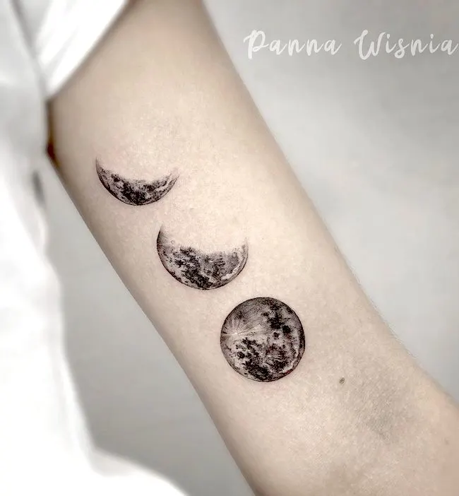 A realistic moon phase tattoo by @pannawisniatattoo