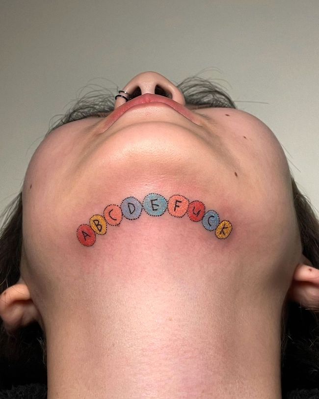 An under-chin tattoo with an attitude - Badass tattoo for women by @imgonnahurtyoubaby