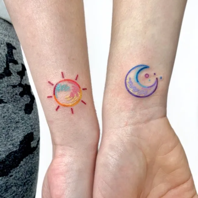 Matching sun and moon wrist tattoo by @xin_tattoooo