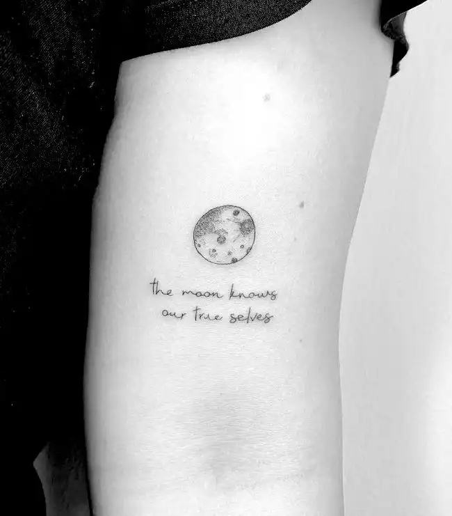 moon tattoo with a quote by @cagridurmaz