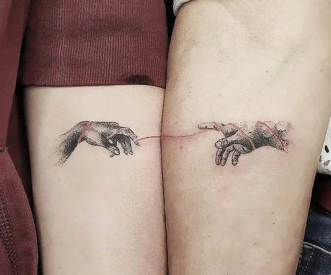 The Creation of Adam - Matching family tattoos by @elodie.tattoo
