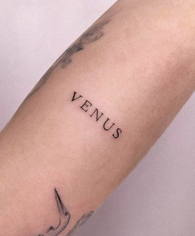 Venus one word tattoo by @nikolett.kapor