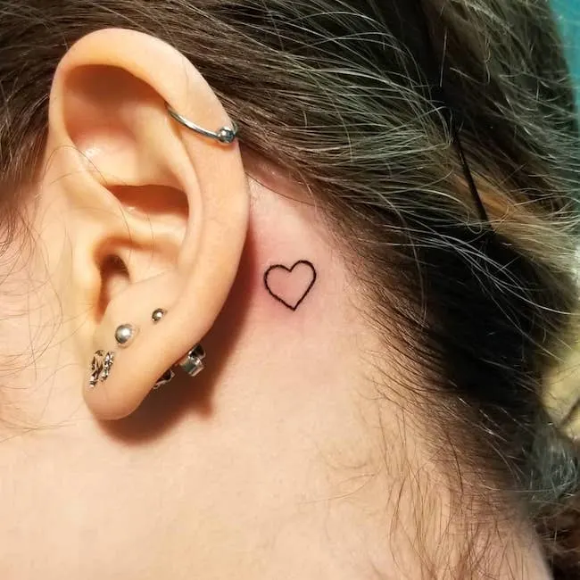 A small heart tattoo behind the ear by @_jose_g_p